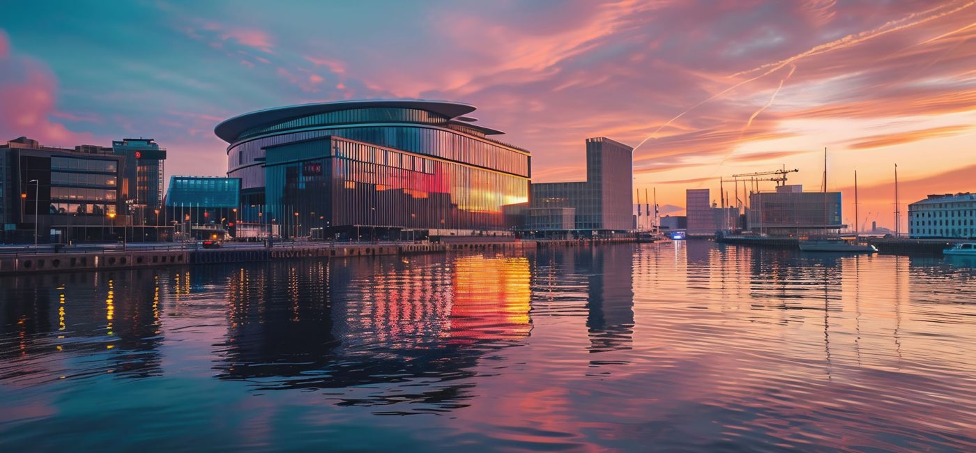 exterior of modern concert hall near the water at night. urban landscape